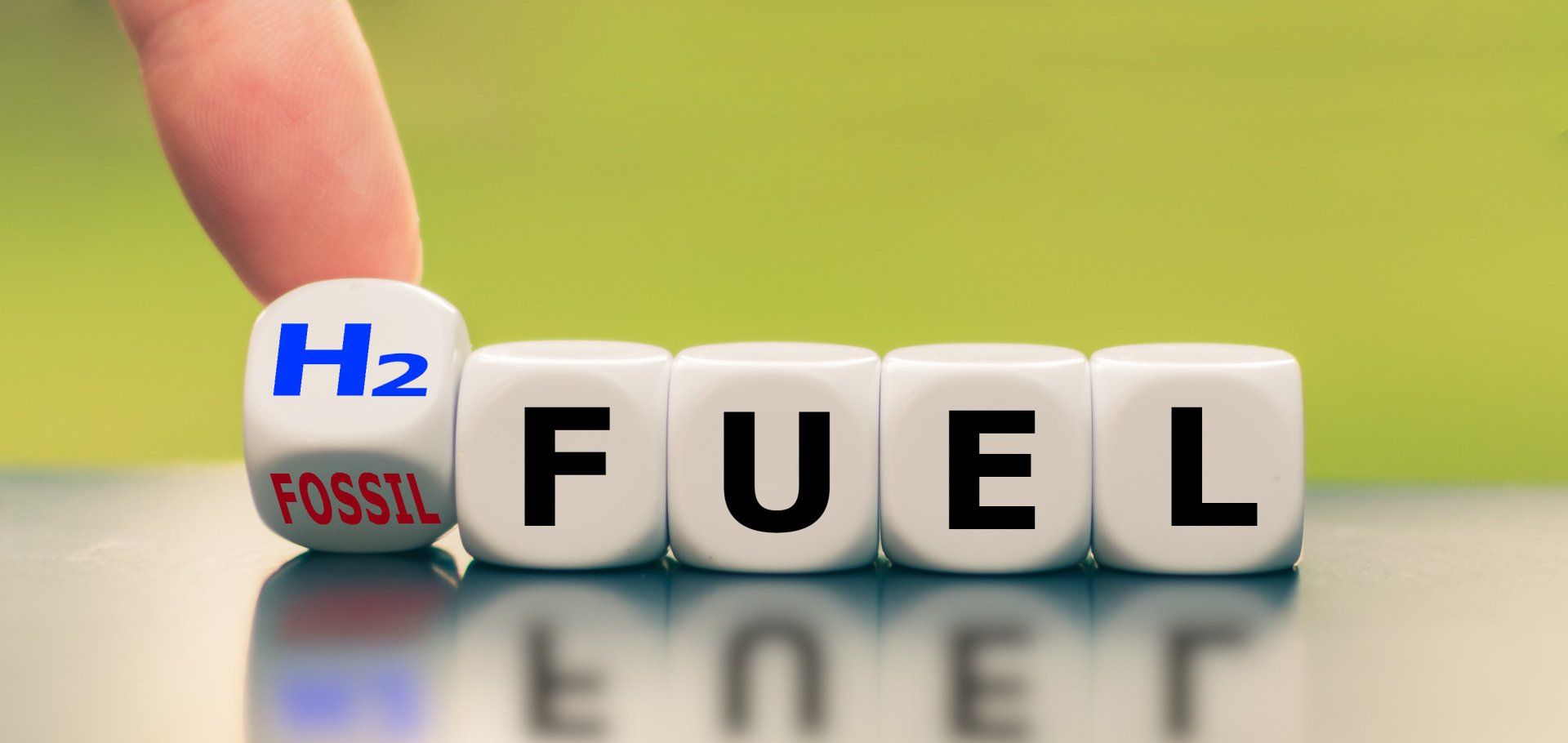 letter dice spelling FUEL with H2 fuel being changed into fossil
