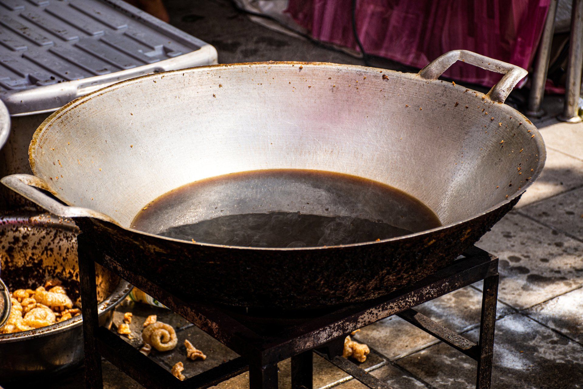 dirty oil in a wok on the street