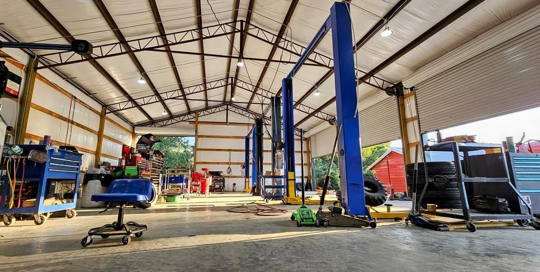 The inside of a garage with a lot of tools and equipment.