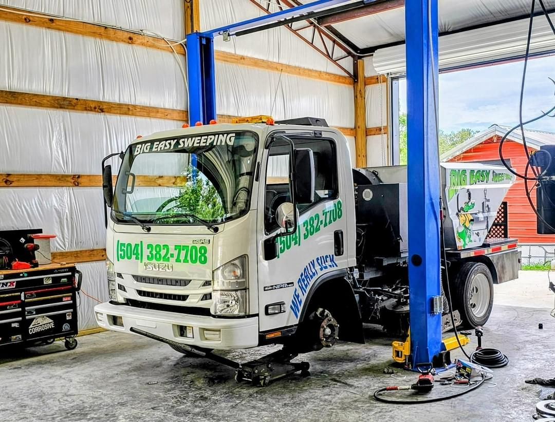 A tow truck is sitting on a lift in a garage.