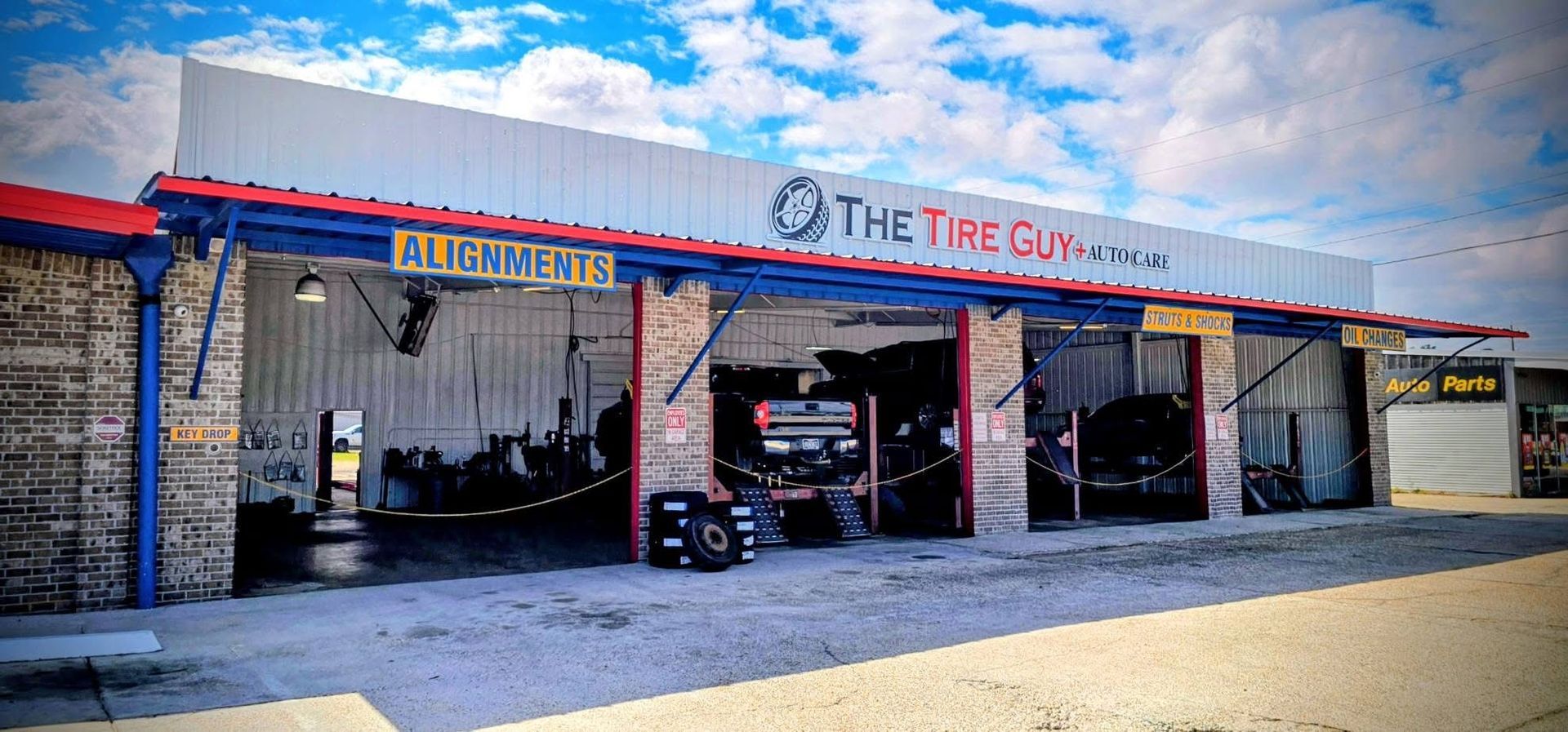 A car is sitting on a lift in a garage.