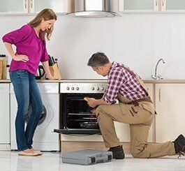 Male Worker Checking The Oven — Appliance Repair in Wauwatosa, WI