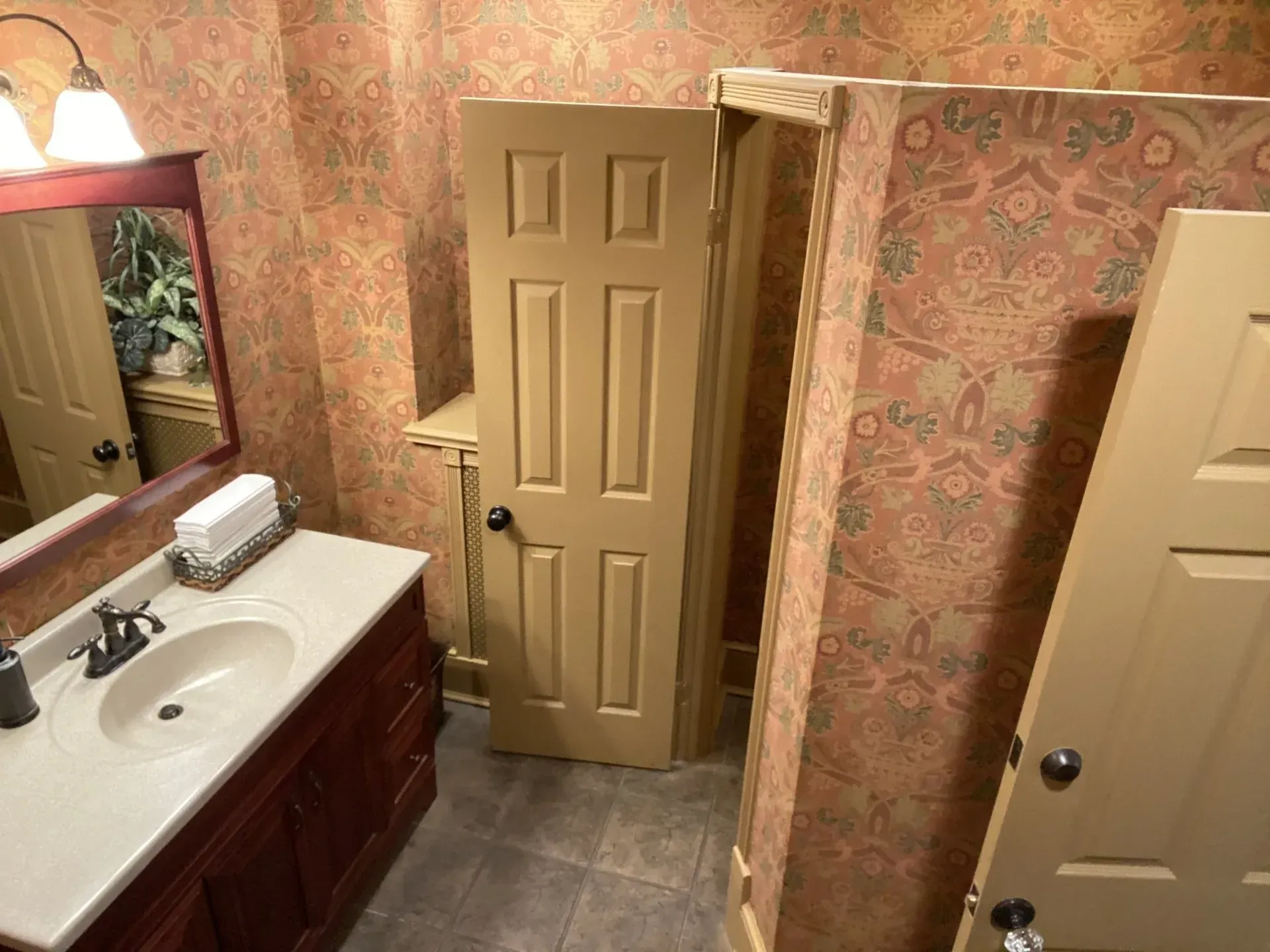 A bathroom with a sink a mirror and a door