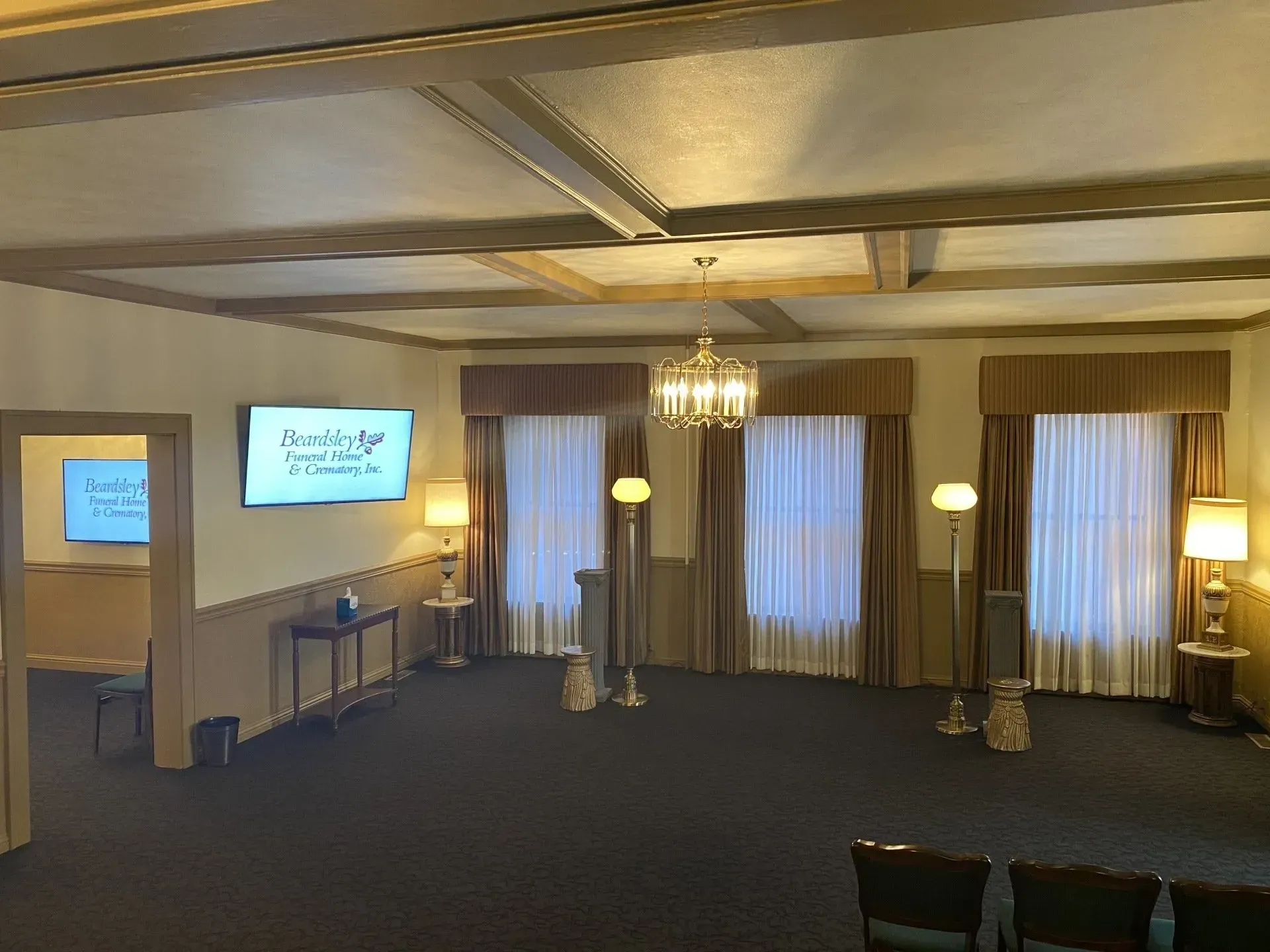 A large room with a lot of windows and a tv on the wall.