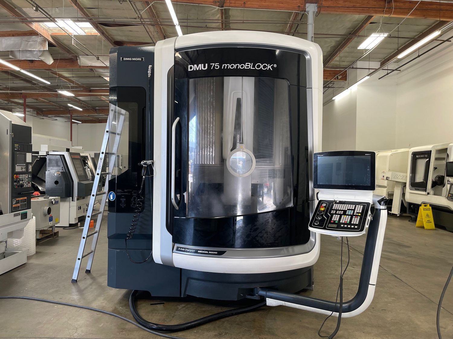 A machine is sitting in a warehouse next to another machine.