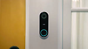 Nest smart doorbell mounted on door in front of house