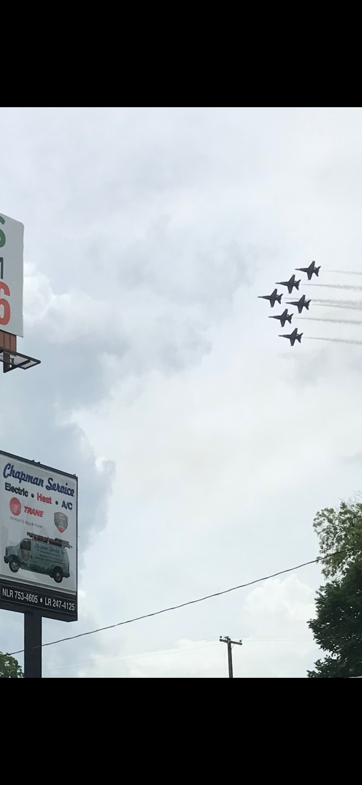A group of planes are flying in formation in the sky