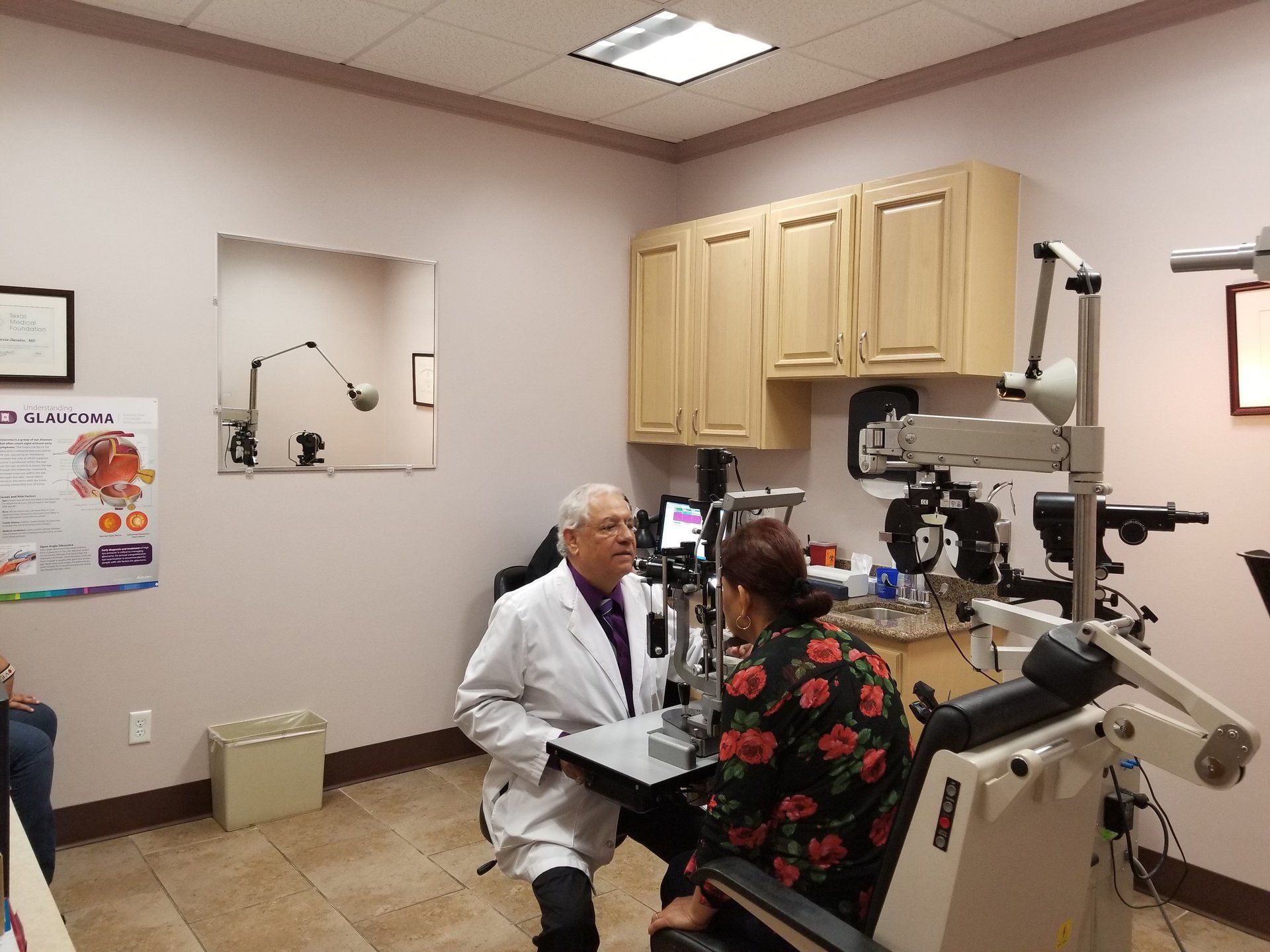 Dr. Jose Garcia-Davalos, MD examines eyes of patient