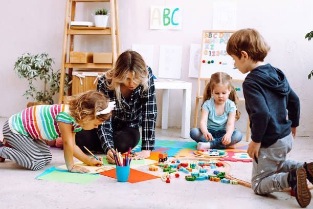 A group of children are playing with toys on the floor.