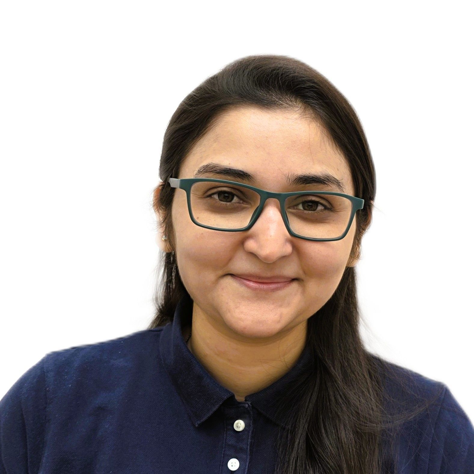A woman wearing glasses and a white shirt is smiling for the camera.