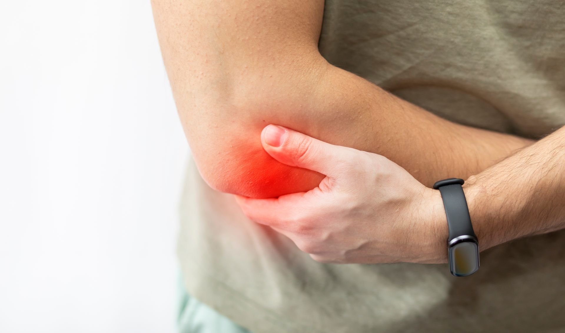 Person holding their red, inflamed elbow, indicating pain.
