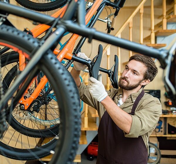 Man Repairing A Bicycle — Gladstone Bicycle Centre in Gladstone, QLD