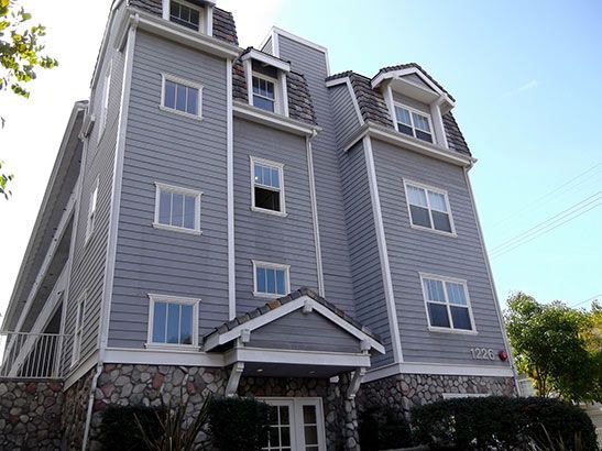 A large building with a lot of windows and a stone facade