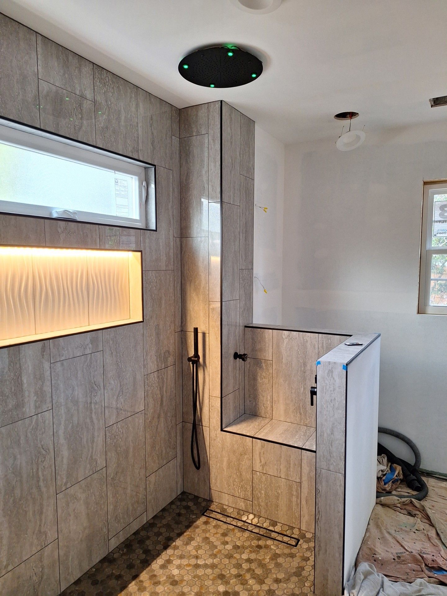 A tile being laid, with a string line and nail for alignment on a bed of mortar.