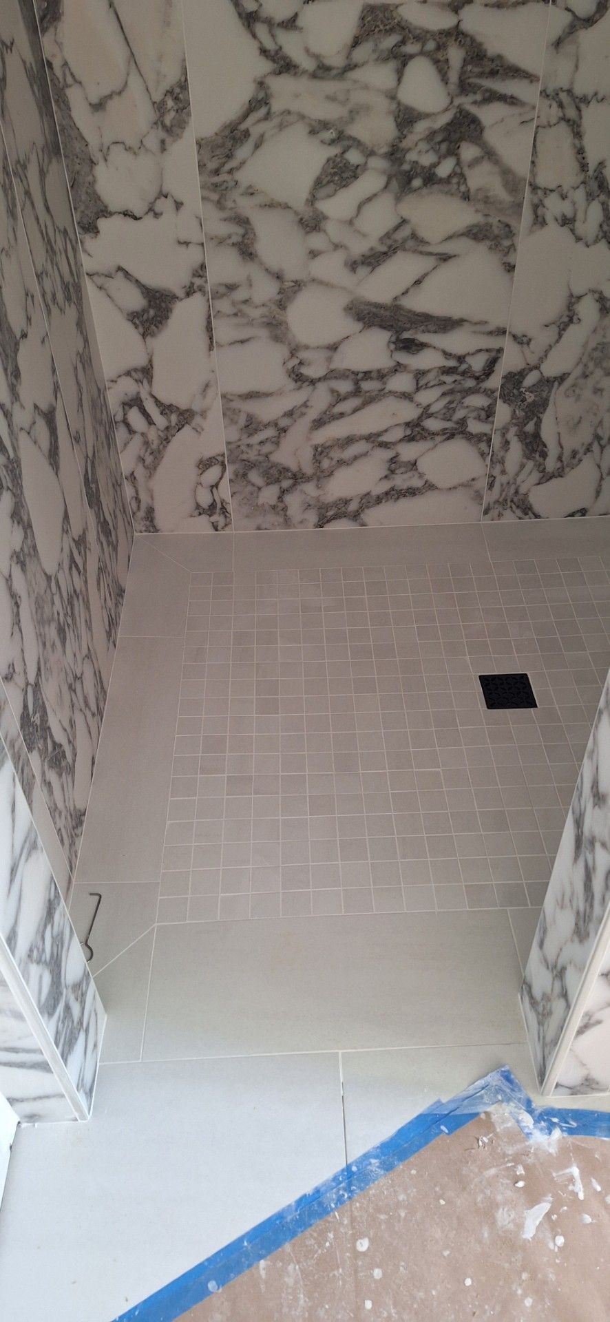 Samples of flooring materials in various textures and colors: wood grain, stone, and textured.