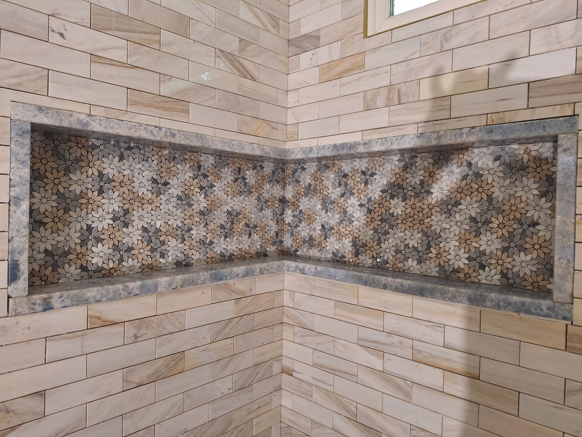 Modern kitchen with black appliances, white cabinets, and dark tile floor.