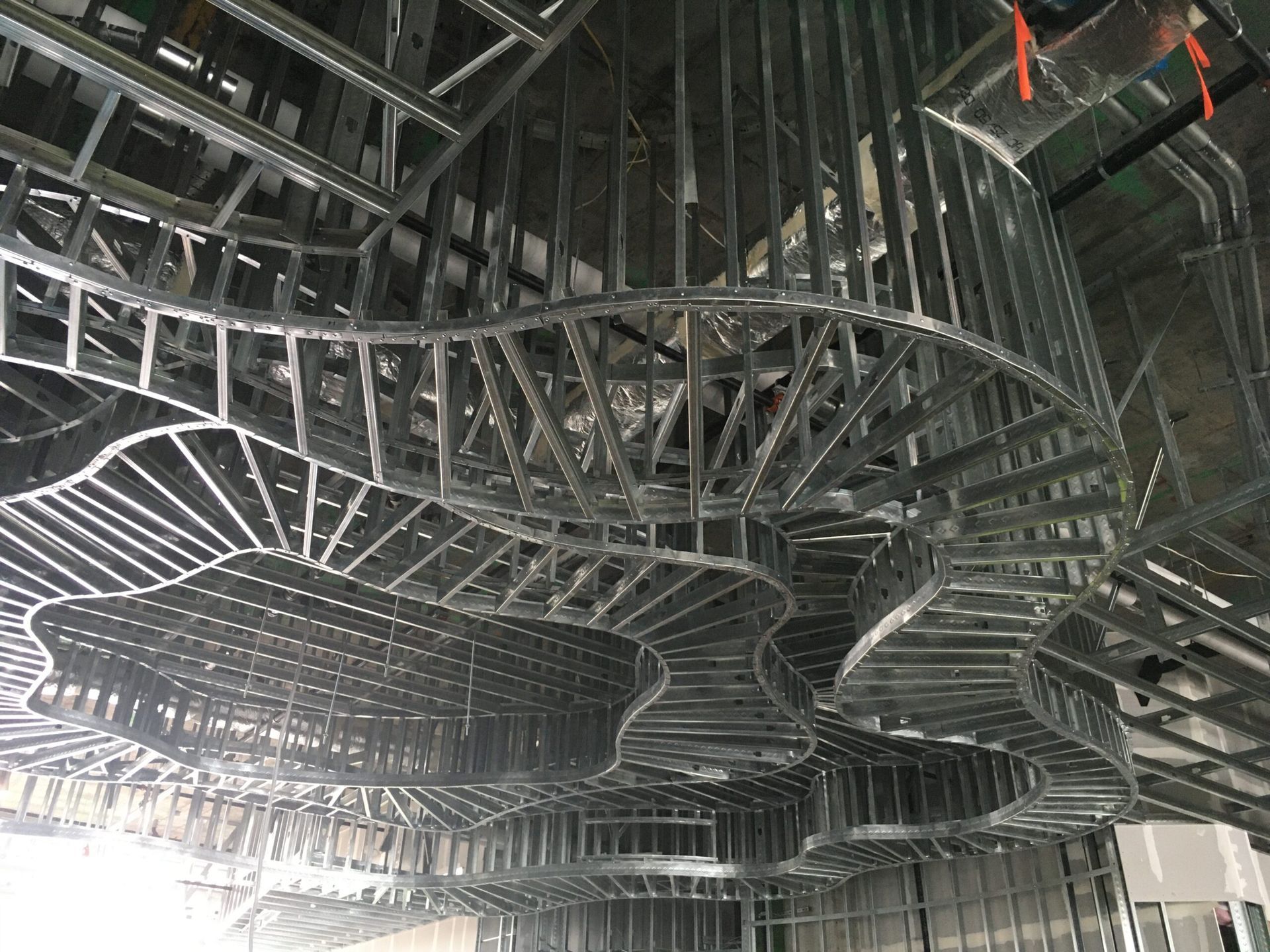 A large metal structure is being built in a building.