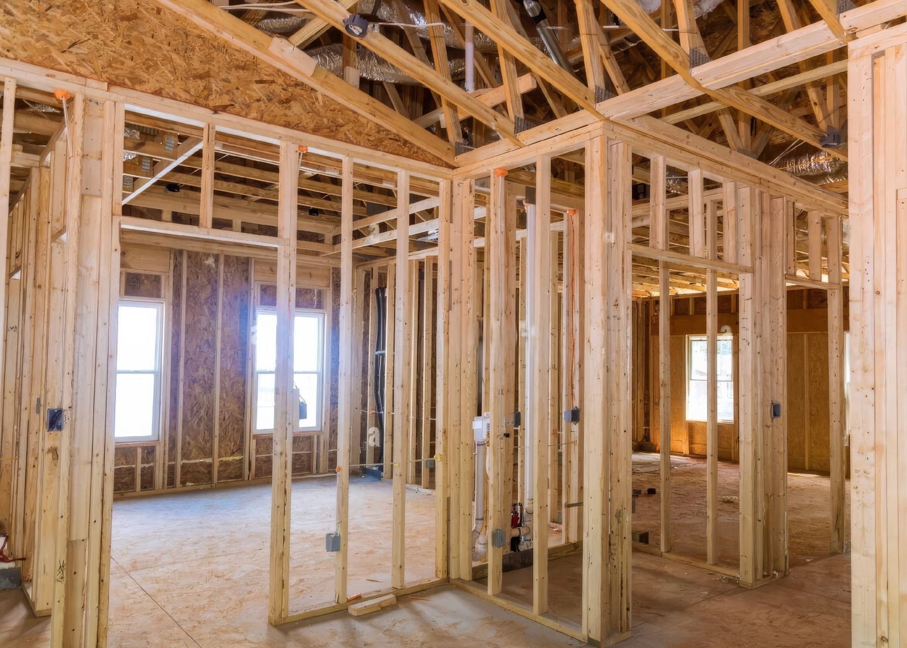 The inside of a house under construction with wooden beams.