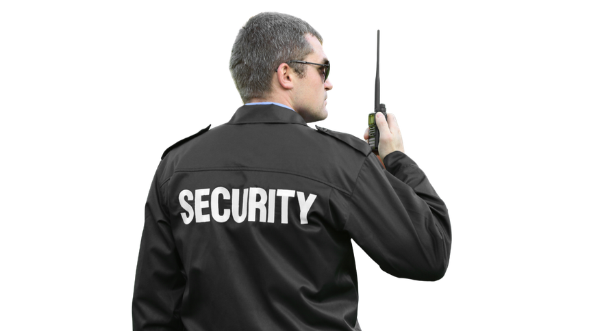 A security guard is talking on a walkie talkie.