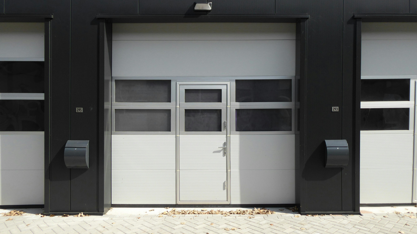 A row of garage doors on a black building