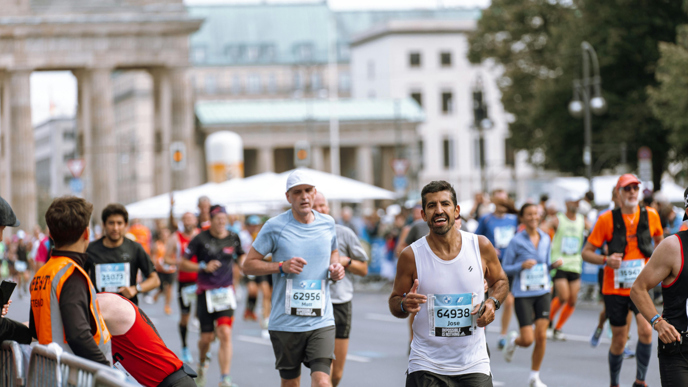 A group of people are running a marathon on a city street.