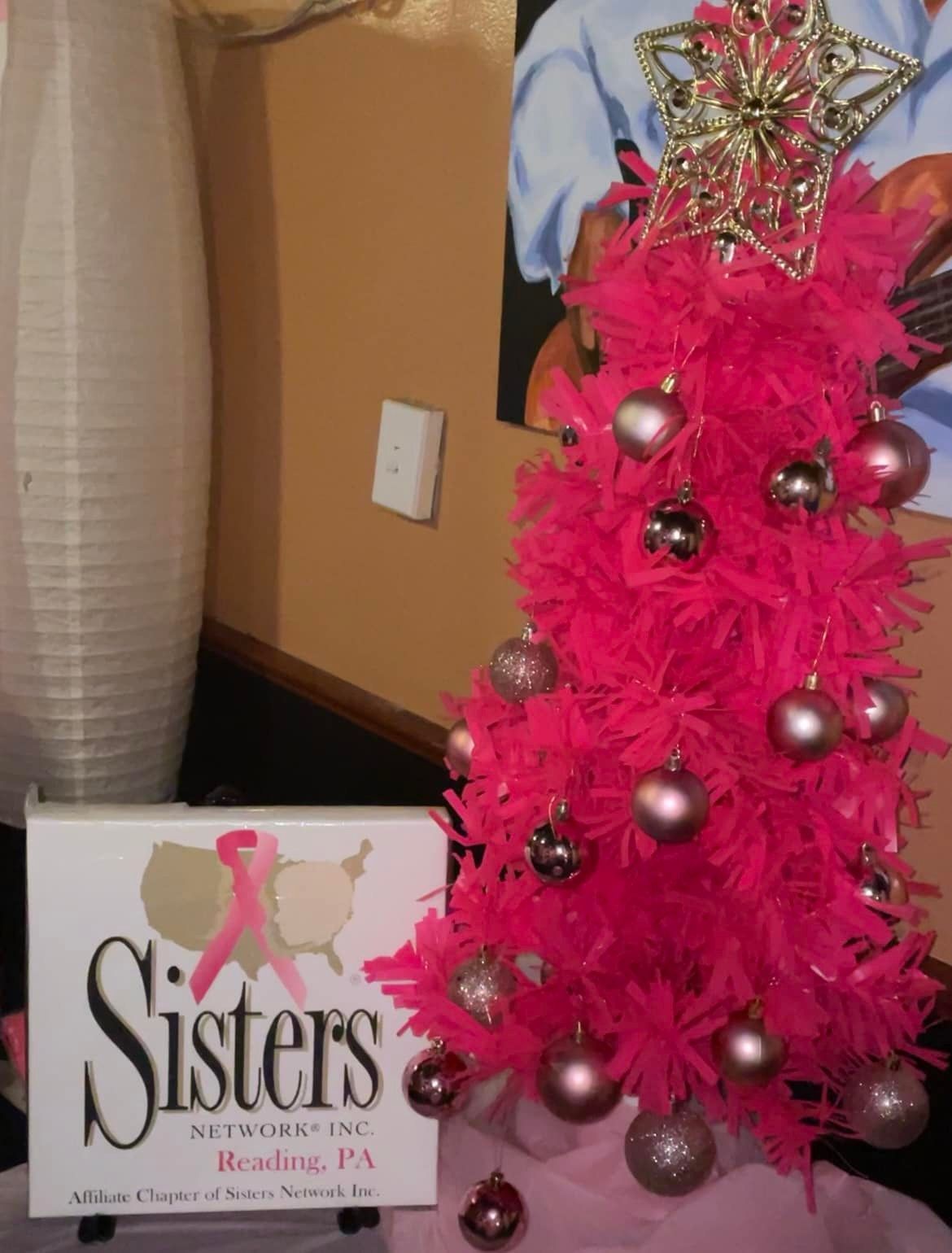 Pink Christmas tree with ornaments, star topper, and 
