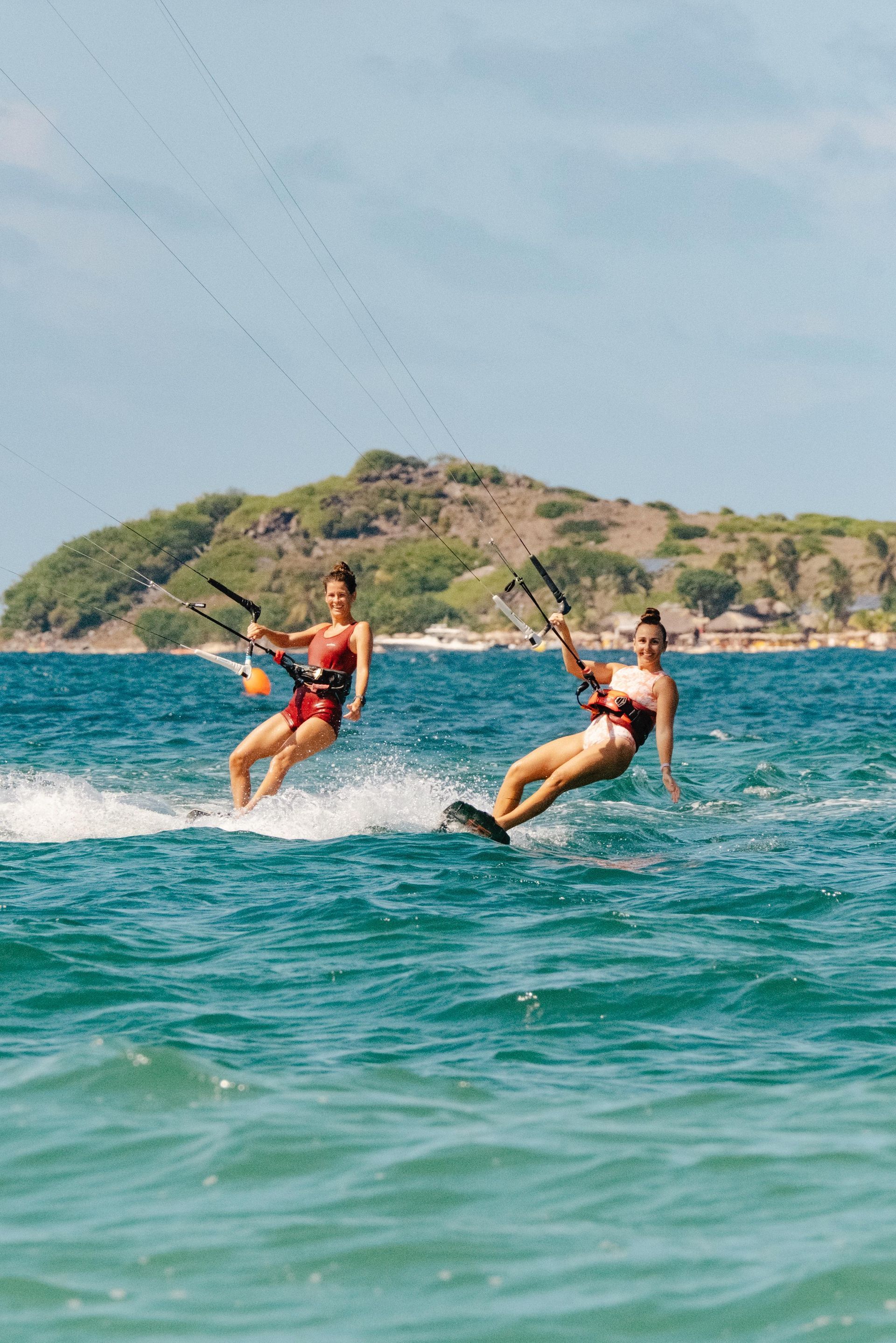 Friends  are riding a wave on a surfboard in the ocean.