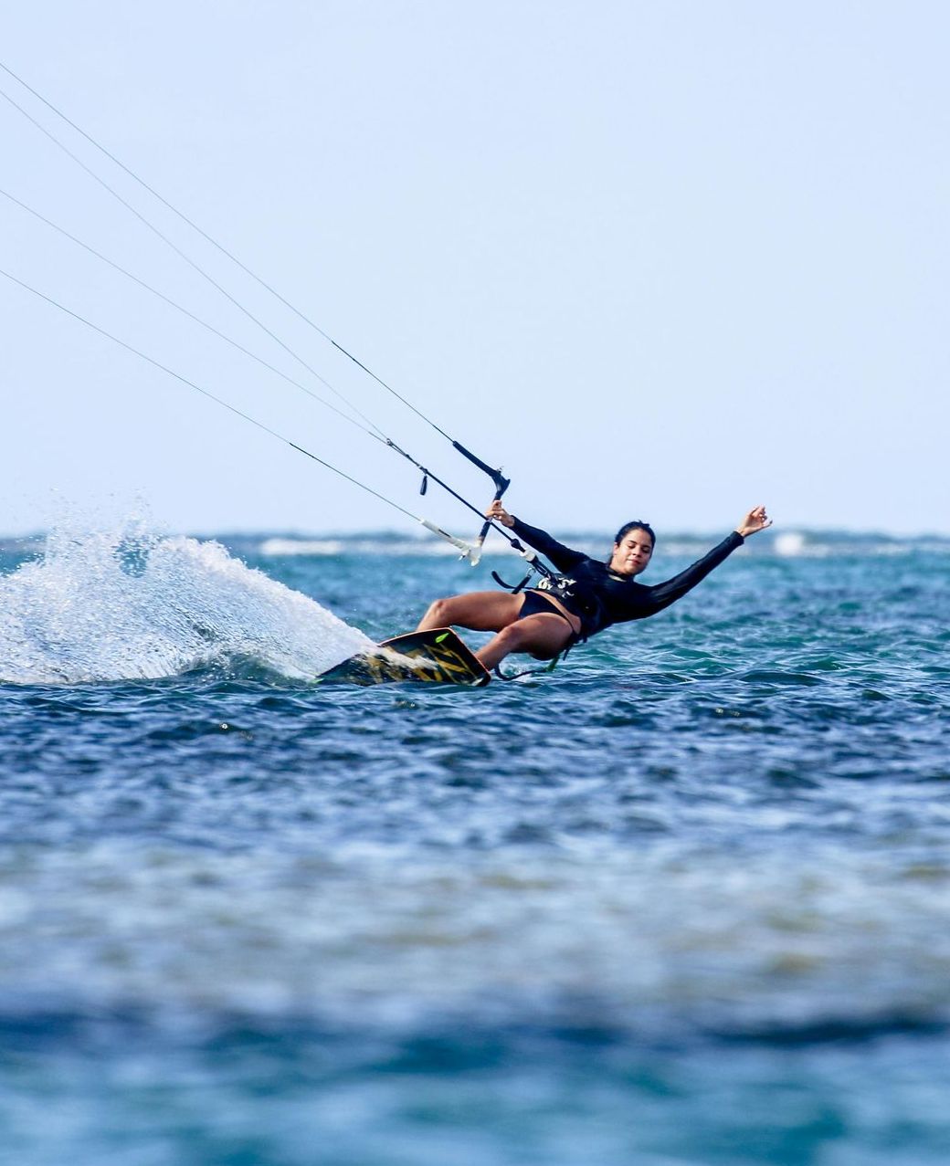 A woman is riding a wave on a surfboard in the ocean.