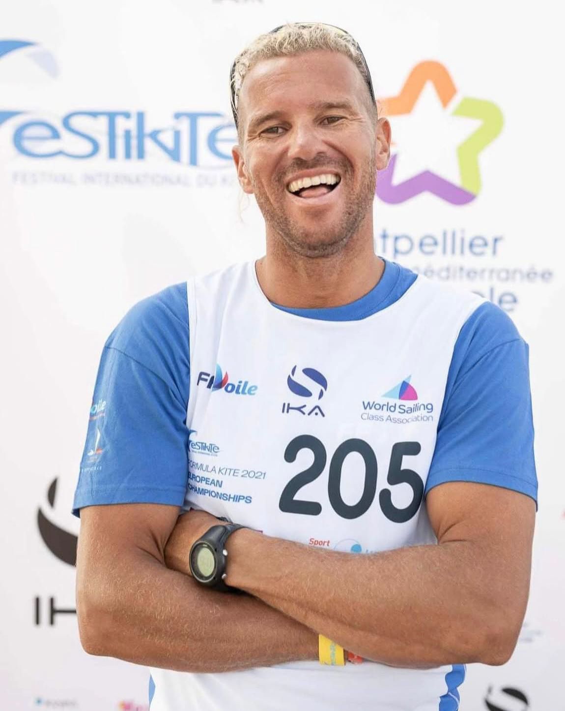 A man wearing a shirt with the number 205 on it