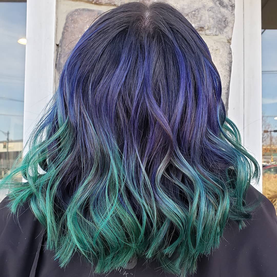 Hairdresser holding a bowl of hair dye and brush, preparing to dye a client's hair.