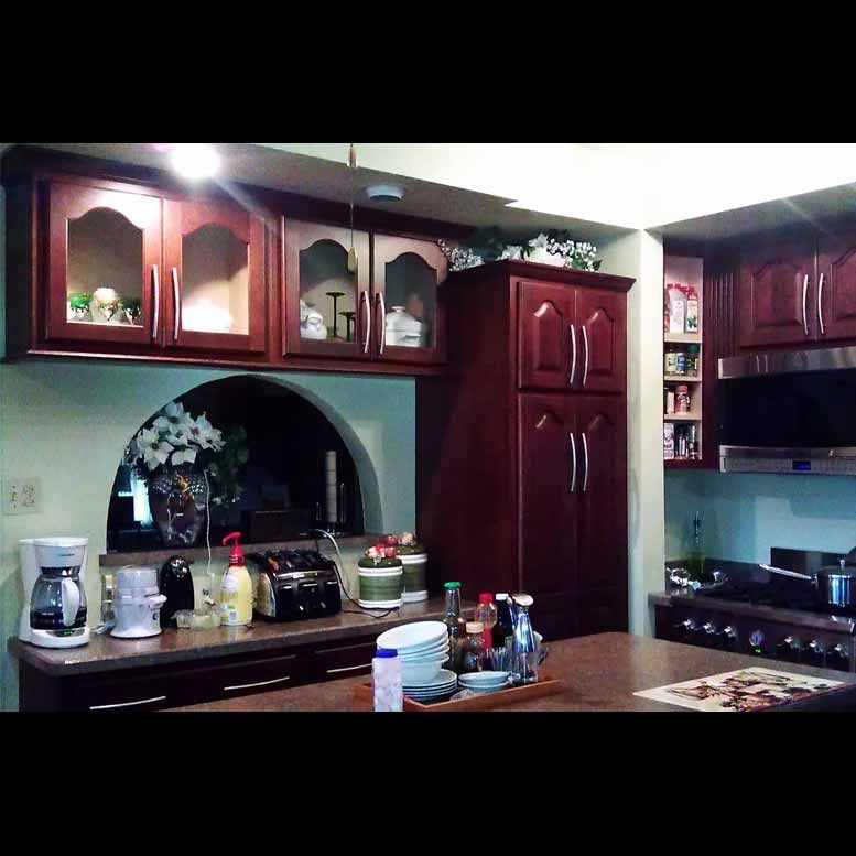 A kitchen with wooden cabinets and stainless steel appliances