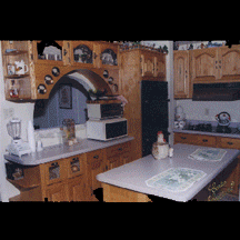 A kitchen with wooden cabinets and white counter tops