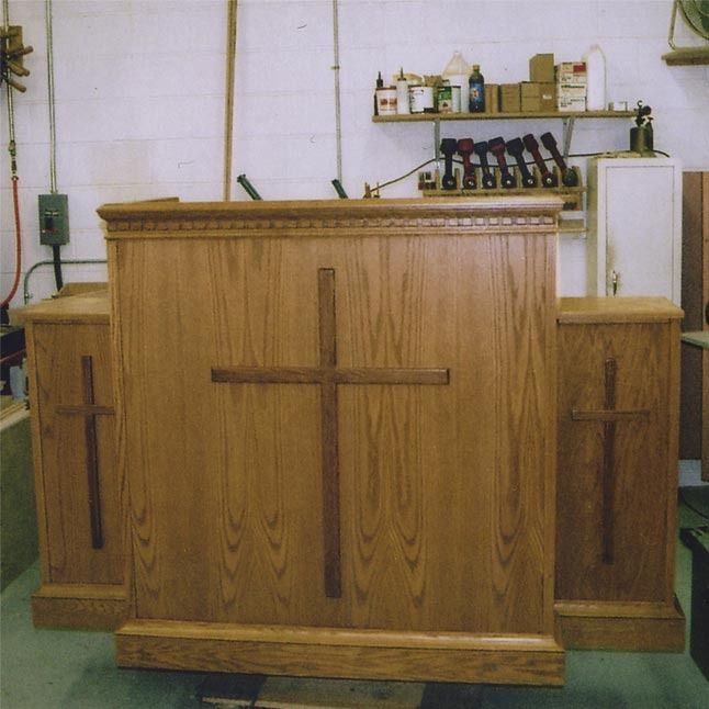 A wooden podium with a cross on it