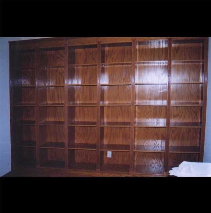 A large wooden bookshelf with lots of shelves