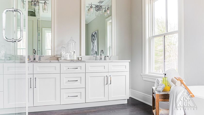 A bathroom with two sinks , two mirrors , a tub and a window.