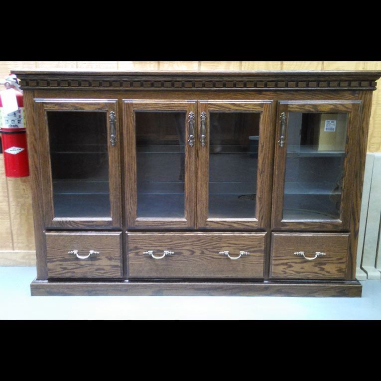 A wooden cabinet with drawers and glass doors