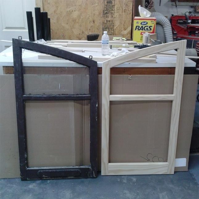 A box of rags sits on a table next to a window frame