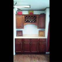 A kitchen with wooden cabinets and a wine rack