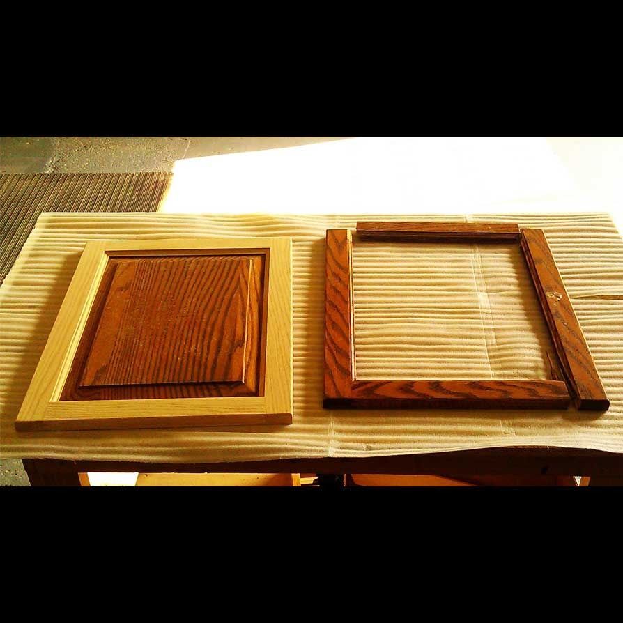 Two wooden frames are sitting on a wooden table