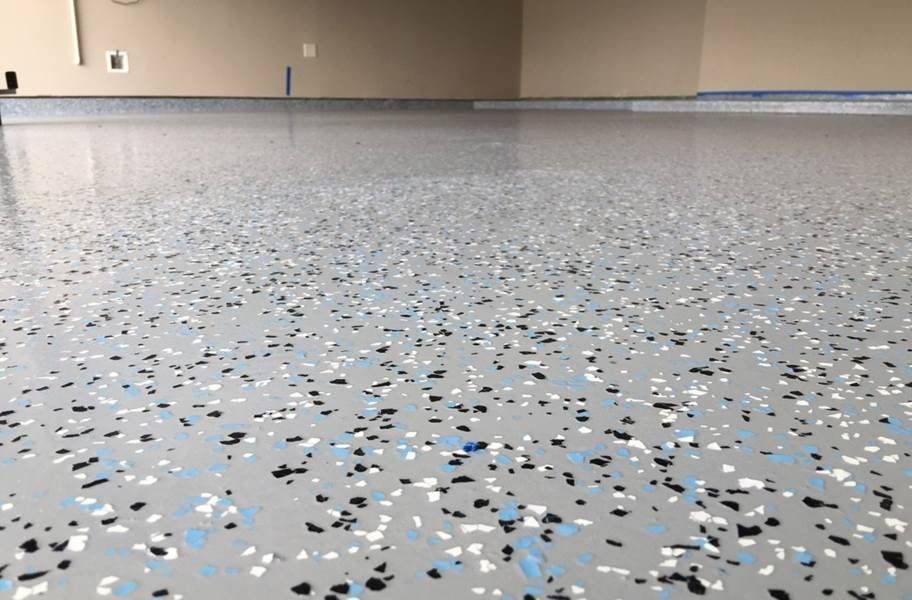 A garage floor with a lot of small stones on it