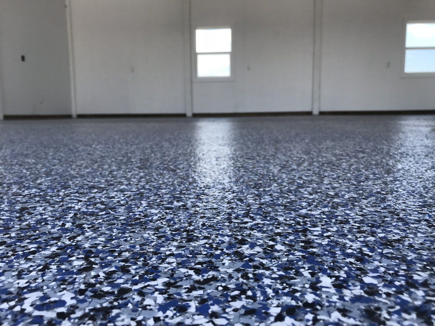 A garage floor with a blue and white camouflage pattern