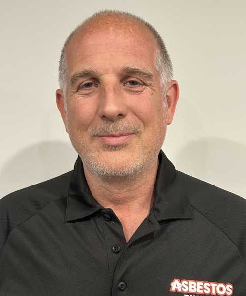 A man wearing a black shirt with the word asbestos on it