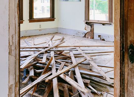 a room with a pile of wood on the floor