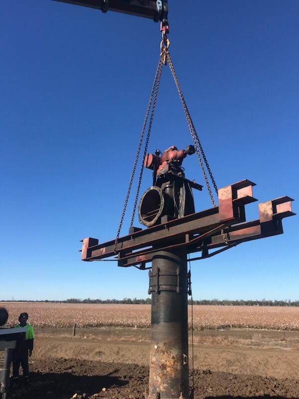 Crane Lifting a Pump From the Ground — Proton Engineering Pty Ltd In Tamworth, NSW
