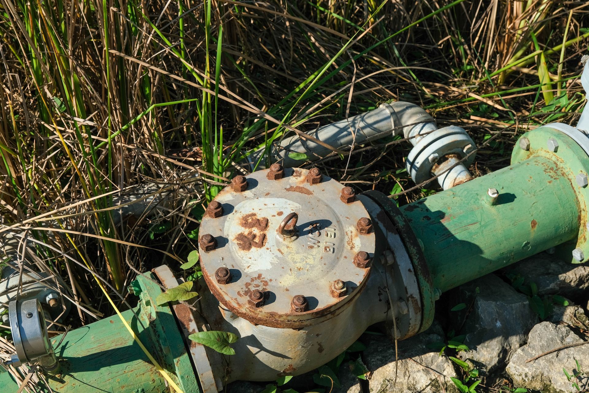 A close up of a green pipe with a valve on it — Proton Engineering Pty Ltd In Gunnedah, NSW