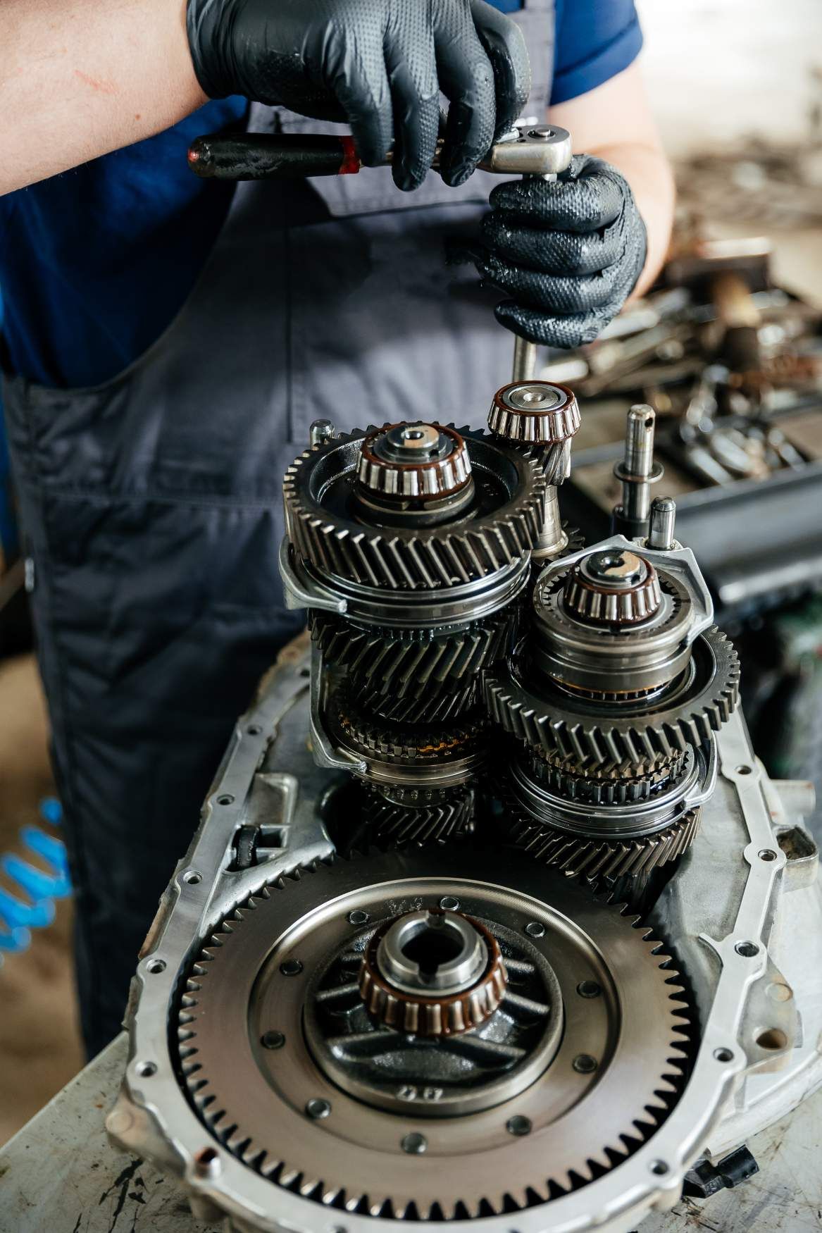A Man is Working on a Gearbox in a Garage — Proton Engineering Pty Ltd In Gunnedah, NSW