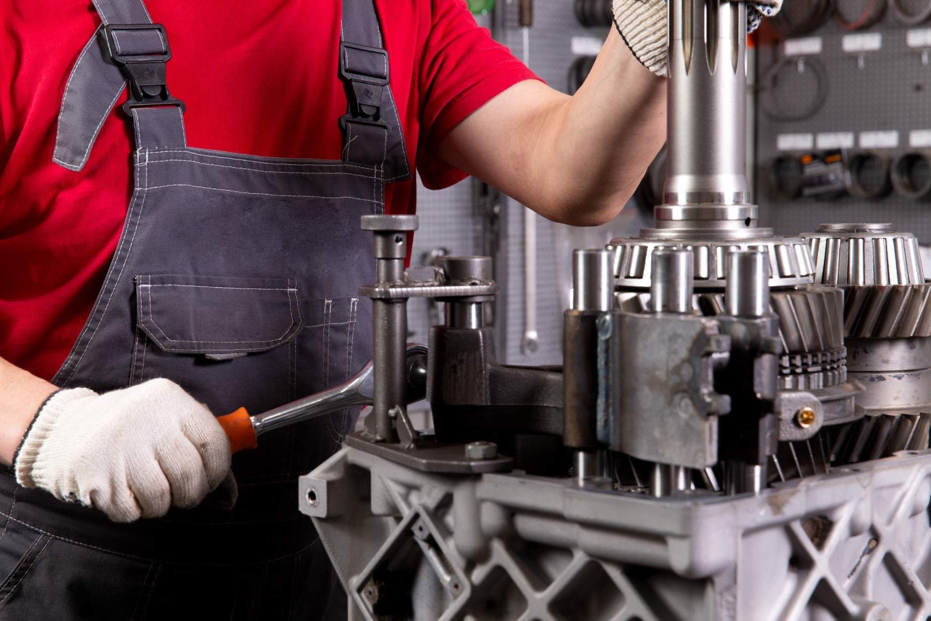 A Man is Working on a Machine With a Screwdriver — Proton Engineering Pty Ltd In Gunnedah, NSW