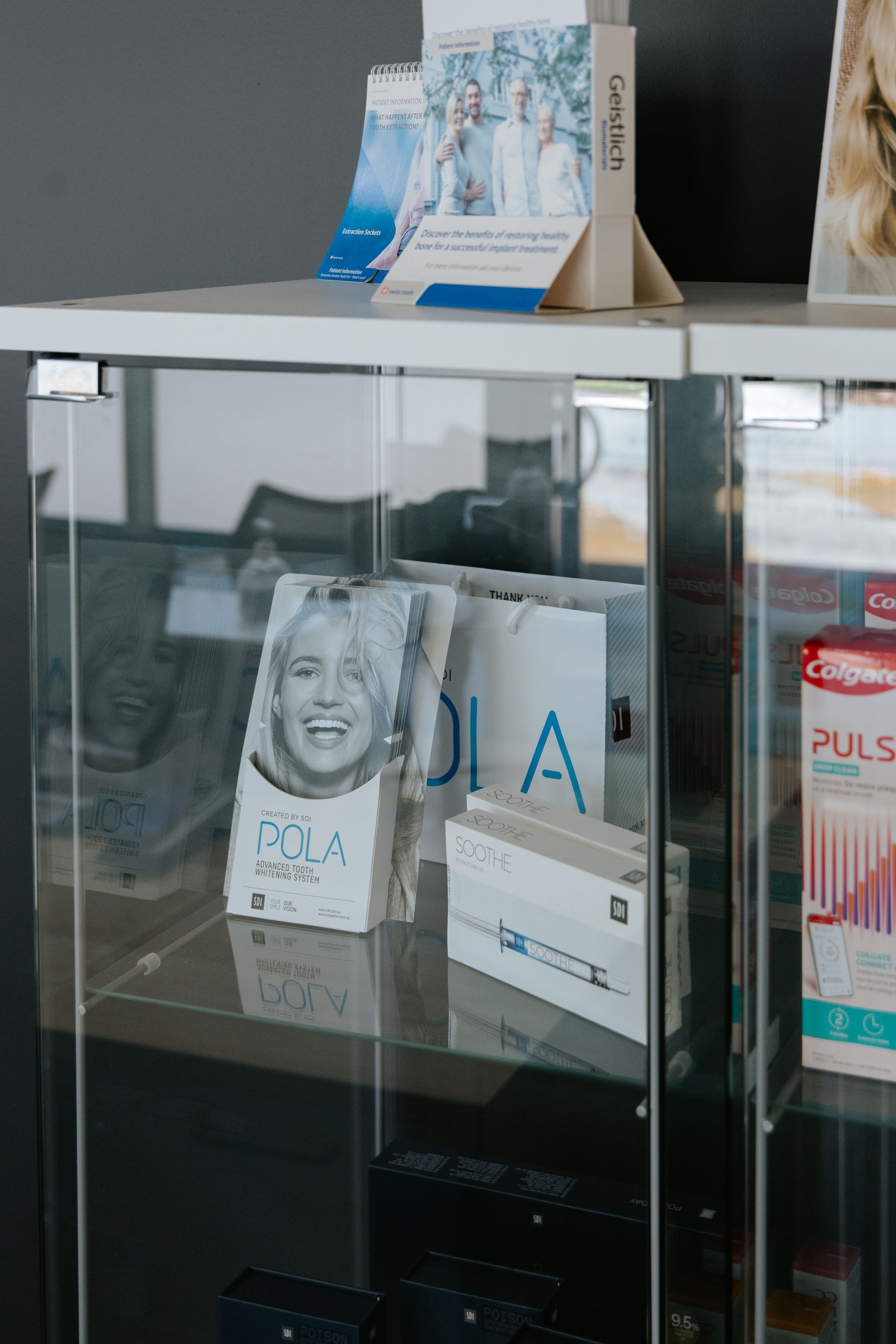 Glass display case with brochures and dental products. — McDonald Dental in Gympie, QLD