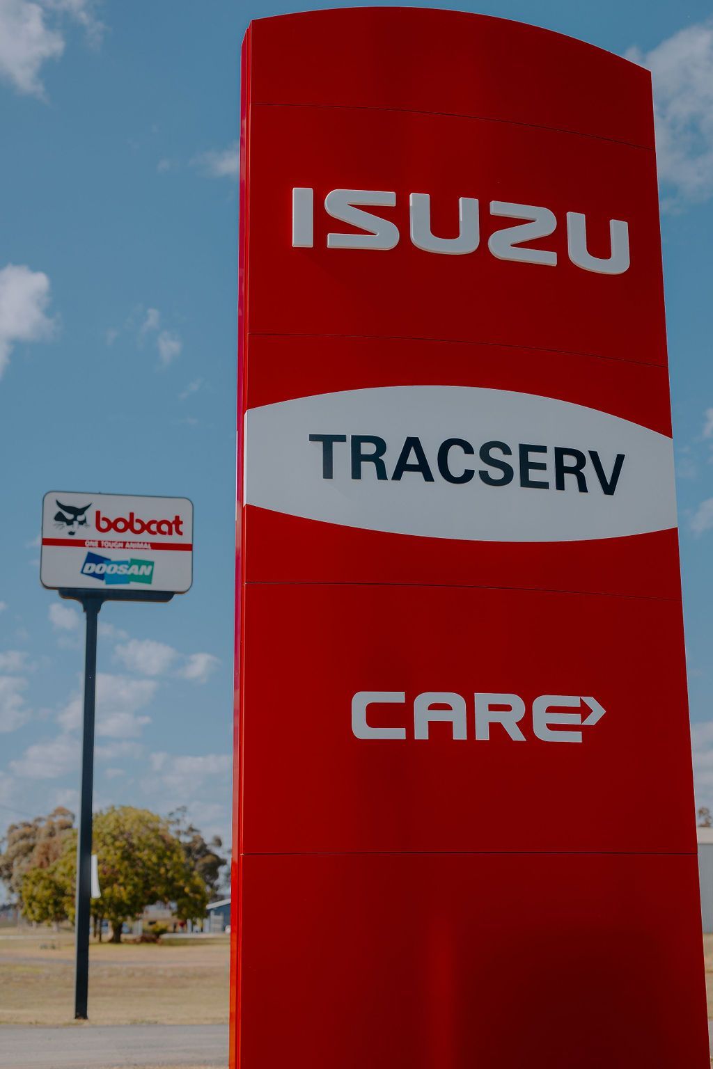 Isuzu Care And Tracserv Sign Board In Front Of A Building — Tracserv in Dubbo, NSW