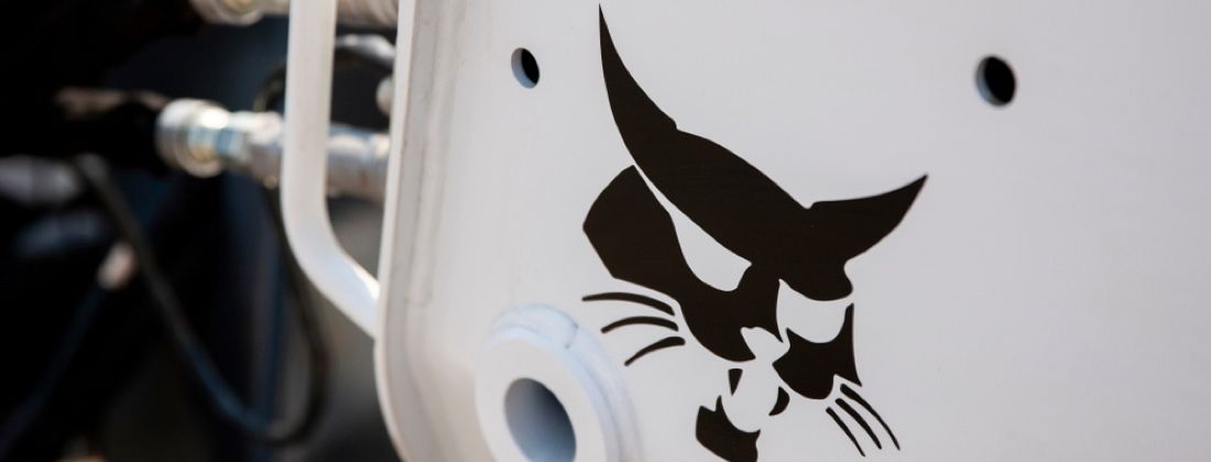 A White Mug With A Bobcat Icon Logo On It — Tracserv in Dubbo, NSW